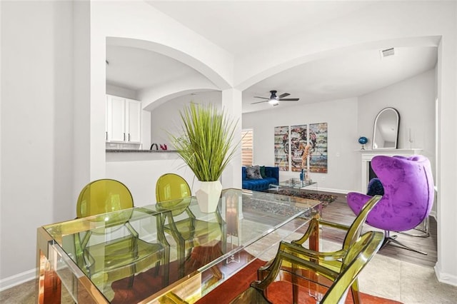 6571 Splitpine Ct, Atlanta, GA 30349 - dining room featuring a ceiling fan, baseboards, and arched walkways