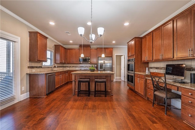 kitchen with a center island, dark wood-style flooring, stainless steel appliances, visible vents, and a sink