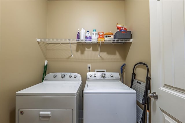 clothes washing area with washer and dryer and laundry area