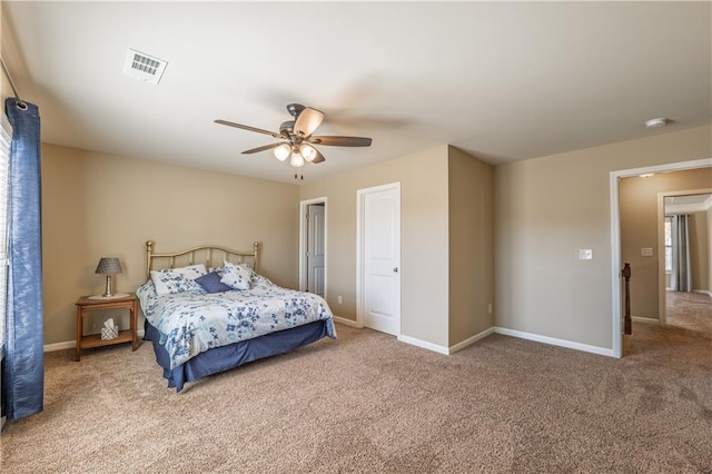 carpeted bedroom featuring a ceiling fan, visible vents, and baseboards