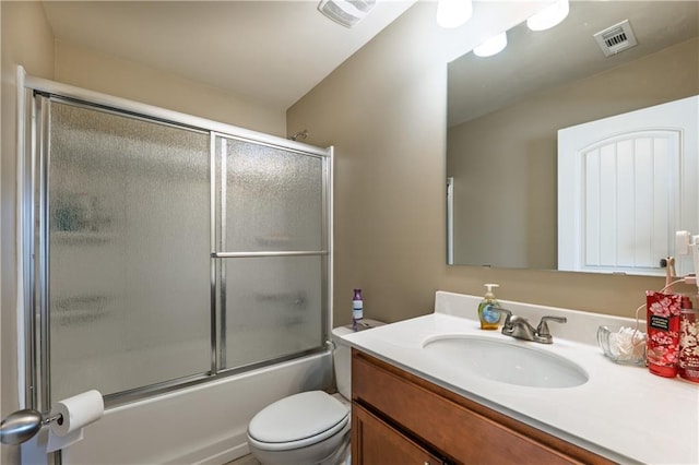 full bathroom featuring toilet, combined bath / shower with glass door, vanity, and visible vents