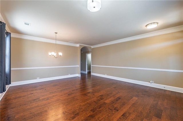 spare room with visible vents, arched walkways, baseboards, dark wood-style floors, and ornamental molding