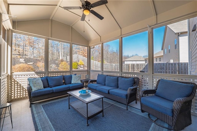 sunroom featuring a ceiling fan, lofted ceiling, and a wealth of natural light