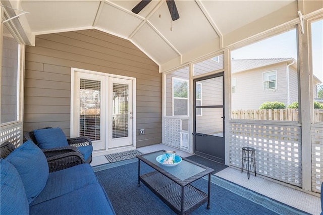 sunroom featuring lofted ceiling, plenty of natural light, and a ceiling fan