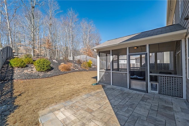 view of patio / terrace featuring a fenced backyard and a sunroom