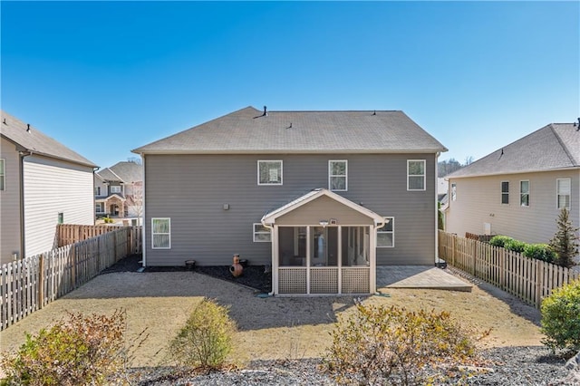 back of house featuring a patio area, a sunroom, and a fenced backyard