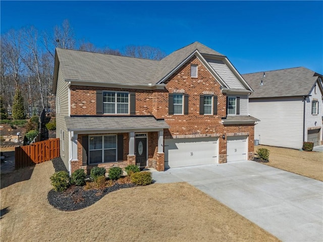 craftsman inspired home featuring brick siding, a shingled roof, fence, a garage, and driveway