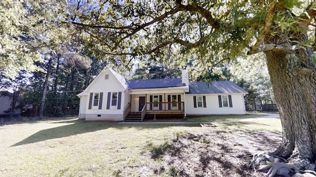 view of front facade featuring a chimney, crawl space, a front yard, and a deck
