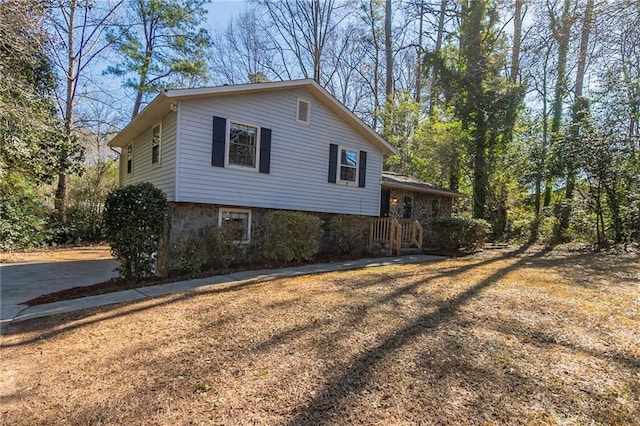 view of side of property with a lawn