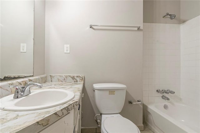 full bathroom featuring tiled shower / bath combo, vanity, and toilet