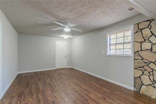 spare room featuring crown molding, ceiling fan, dark hardwood / wood-style floors, and a textured ceiling