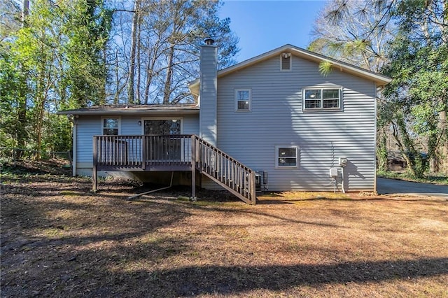 rear view of property with a wooden deck