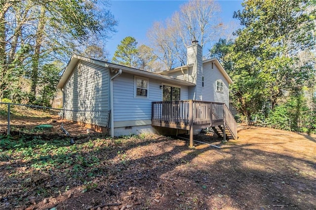 rear view of house featuring a deck