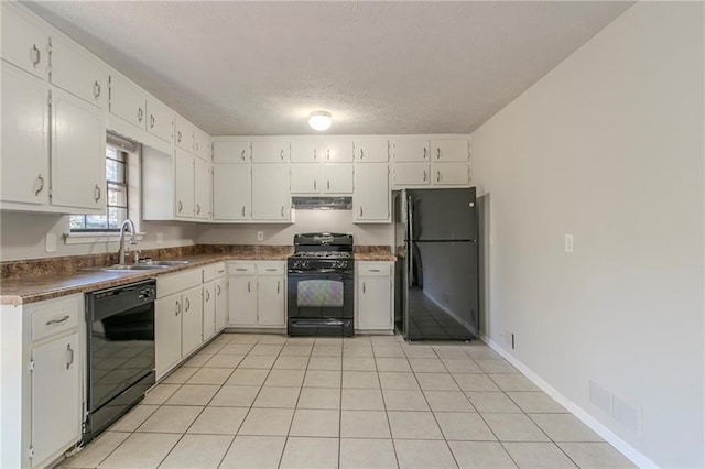 kitchen with white cabinets, light tile patterned floors, sink, and black appliances