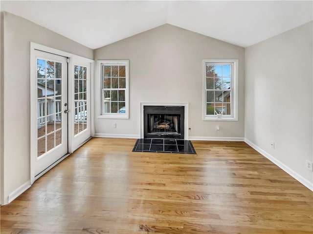 unfurnished living room featuring light hardwood / wood-style floors and lofted ceiling