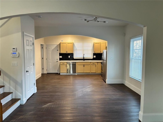 kitchen featuring dark hardwood / wood-style flooring, backsplash, stainless steel appliances, and sink