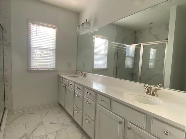 bathroom featuring plenty of natural light, vanity, and a shower with door