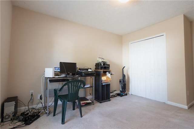 carpeted home office featuring baseboards