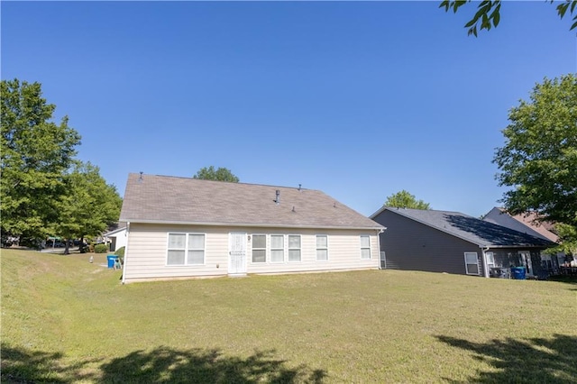 back of property with a lawn