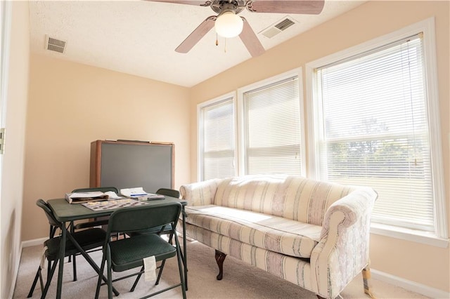 sitting room with carpet flooring, baseboards, and a ceiling fan