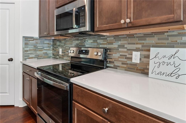 kitchen with decorative backsplash and appliances with stainless steel finishes