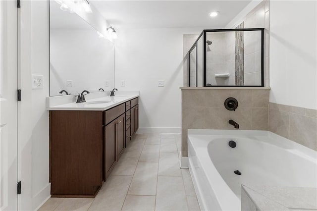 bathroom with tile patterned flooring, vanity, and shower with separate bathtub