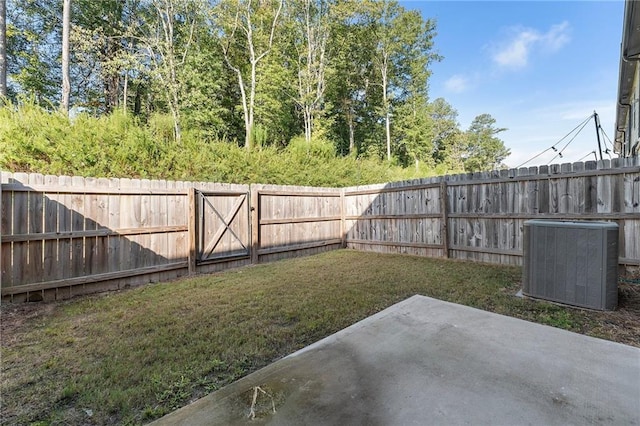 view of yard featuring cooling unit and a patio