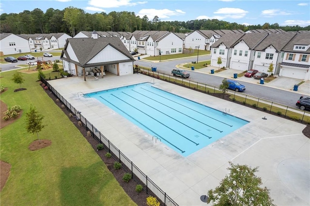 view of swimming pool featuring a yard and a patio area