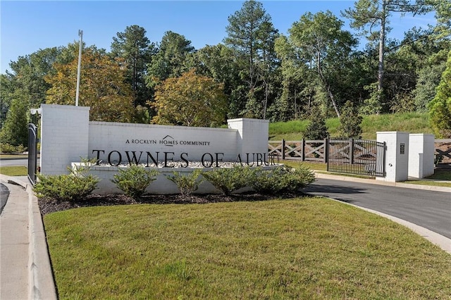 community sign featuring a lawn