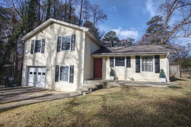 split level home featuring a front lawn and a garage