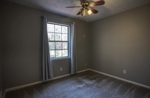 unfurnished room with a textured ceiling, ceiling fan, and carpet