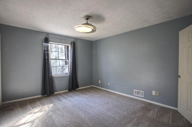 carpeted empty room with a textured ceiling and ceiling fan