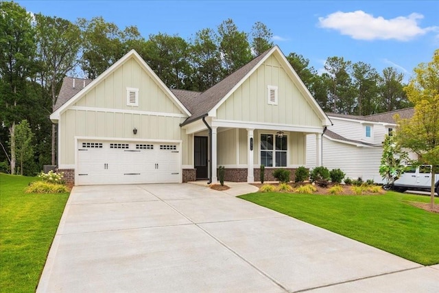 view of front of house with a garage, covered porch, and a front yard