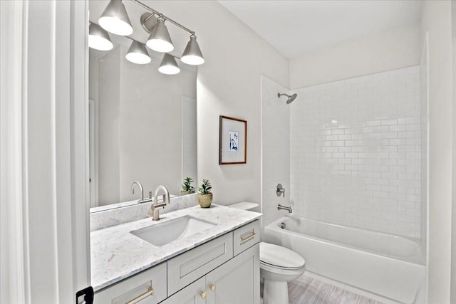 full bathroom with vanity, toilet, and tiled shower / bath combo