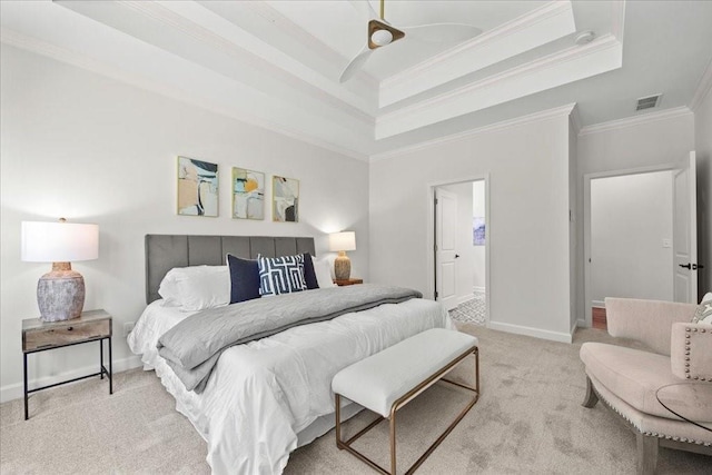 carpeted bedroom featuring a tray ceiling and ornamental molding