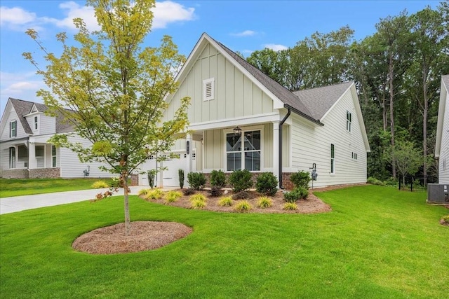 view of front of house featuring a garage, central AC, and a front yard