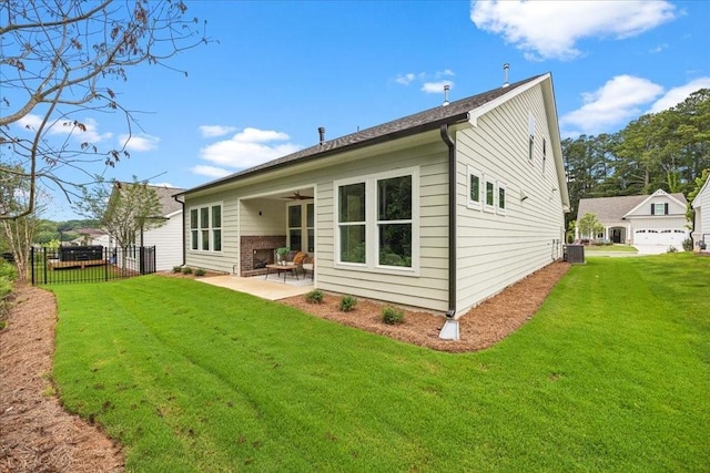 back of house featuring central AC, ceiling fan, a yard, and a patio