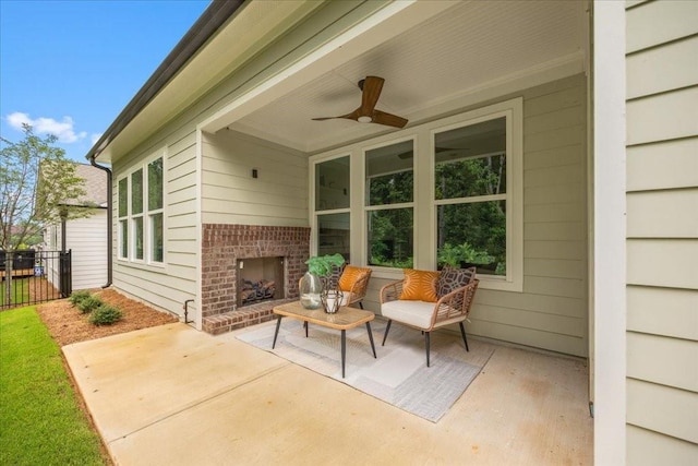 view of patio with an outdoor brick fireplace and ceiling fan