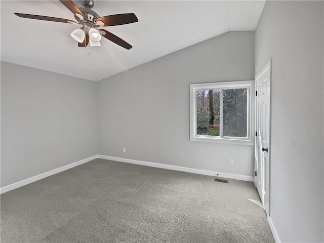 carpeted empty room featuring ceiling fan and vaulted ceiling