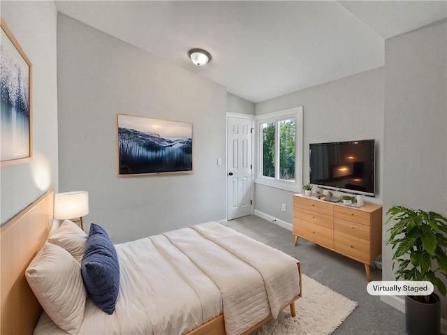 carpeted bedroom featuring vaulted ceiling