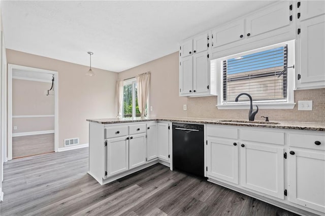 kitchen with visible vents, a sink, white cabinetry, and dishwasher