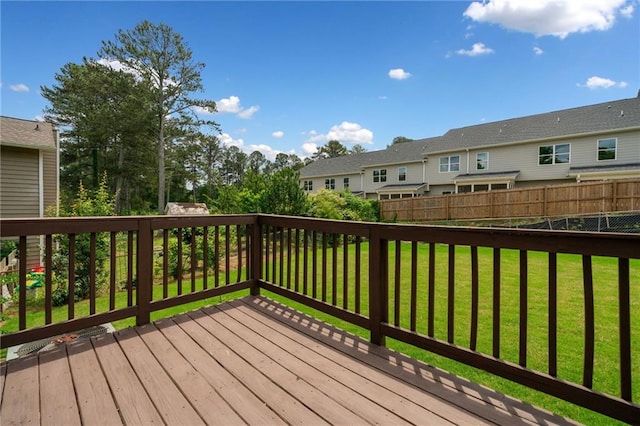 deck with a lawn, fence, and a residential view