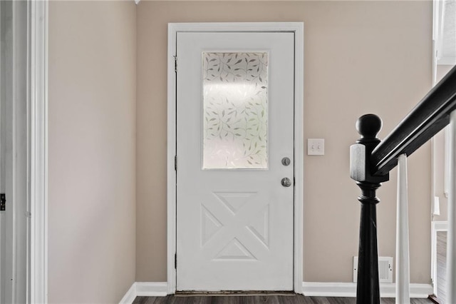 entryway with baseboards, wood finished floors, and visible vents