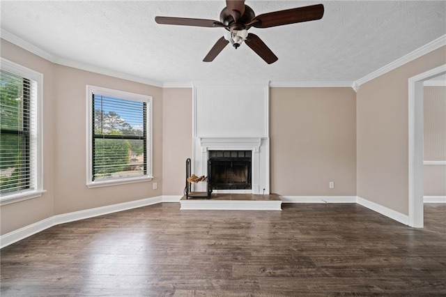 unfurnished living room with crown molding, a ceiling fan, dark wood-style floors, and a tile fireplace