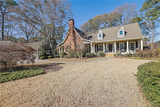 new england style home with a porch