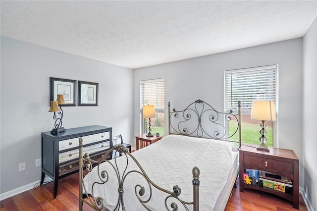 212 Brittany Ct, Duluth, GA 30096 - bedroom with wood finished floors, baseboards, and a textured ceiling