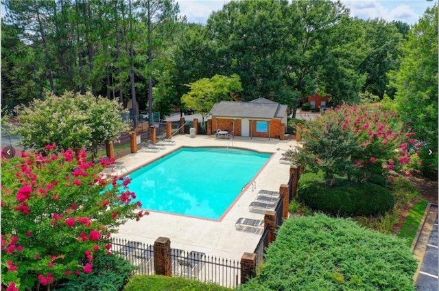 212 Brittany Ct, Duluth, GA 30096 - community pool featuring a patio area and an outbuilding