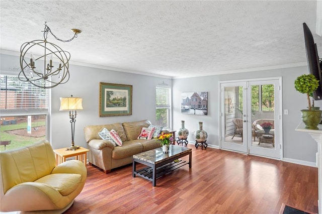 212 Brittany Ct, Duluth, GA 30096 - living area featuring a chandelier, wood finished floors, crown molding, french doors, and baseboards