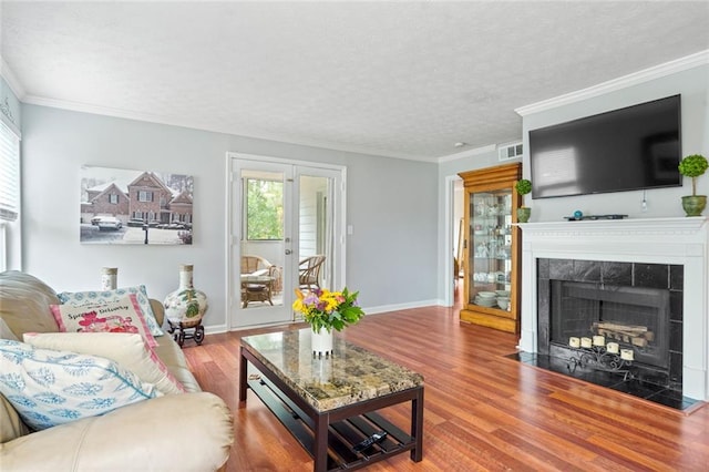 212 Brittany Ct, Duluth, GA 30096 - living area featuring wood finished floors, a fireplace, baseboards, a textured ceiling, and crown molding