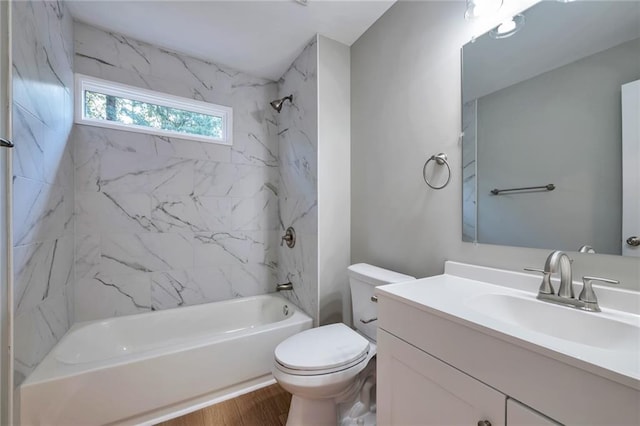 full bathroom with toilet, vanity, tiled shower / bath combo, and hardwood / wood-style flooring